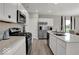 The kitchen features an island, stainless steel appliances, and white cabinets at 4542 Laughter Ln, Indianapolis, IN 46235