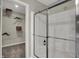 Bright, modern shower with glass door and chrome fixtures, adjacent to an organized walk-in closet at 4542 Laughter Ln, Indianapolis, IN 46235