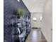 Hallway features a modern console table, decorative wallpaper, and a light wood floor at 4554 Laughter Ln, Indianapolis, IN 46235