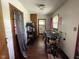 Hallway featuring wood-look flooring, storage shelving, and access to other areas of the home at 4711 Earlham Dr, Indianapolis, IN 46227
