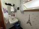 Cute powder room with a unique Eiffel Tower theme, decorative mirror and window at 4711 Earlham Dr, Indianapolis, IN 46227