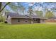 A view of the the back of a charming single story brick home with a large manicured green lawn at 5168 E Walnut Dr, Mooresville, IN 46158