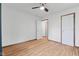 Bright bedroom featuring hardwood floors, white walls, ceiling fan, and closet at 5168 E Walnut Dr, Mooresville, IN 46158