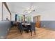 Elegant dining room featuring a large table with seating for ten, wood flooring, and stylish decor at 5168 E Walnut Dr, Mooresville, IN 46158