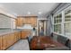 Cozy kitchen with wood cabinets, stainless steel appliances, and a dining area by a window at 5168 E Walnut Dr, Mooresville, IN 46158