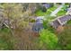 Aerial view of a charming blue home with a dark roof surrounded by lush green trees at 524 Deerberry Dr, Noblesville, IN 46062