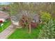 Aerial view highlights a blue home with brick accents and a large yard featuring mature trees at 524 Deerberry Dr, Noblesville, IN 46062