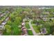 Aerial neighborhood view with tree-lined streets, homes, and a glimpse of a lake in the background at 524 Deerberry Dr, Noblesville, IN 46062
