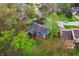 Aerial view of a blue two-story home surrounded by lush trees, showcasing its serene and private setting at 524 Deerberry Dr, Noblesville, IN 46062