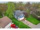 Aerial view of a blue two-story home featuring a basketball court and well-manicured lawn at 524 Deerberry Dr, Noblesville, IN 46062