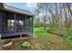View of the back of the home with a screened porch and an expansive yard at 524 Deerberry Dr, Noblesville, IN 46062