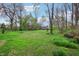 Spacious backyard featuring a fire pit and mature trees, perfect for outdoor activities and relaxation at 524 Deerberry Dr, Noblesville, IN 46062