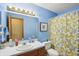 Bathroom features a blue color scheme, single vanity, and shower with decorative curtain at 524 Deerberry Dr, Noblesville, IN 46062
