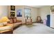 Well-lit room with a large window, a settee, plants, and vintage decor at 524 Deerberry Dr, Noblesville, IN 46062