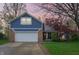 Charming home with blue siding, brick accents, an attached garage, and a well-maintained front lawn at 524 Deerberry Dr, Noblesville, IN 46062