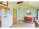Well-lit eat-in kitchen with matching appliances and a refrigerator with icemaker at 524 Deerberry Dr, Noblesville, IN 46062