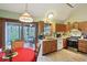 Eat-in kitchen with matching appliances and hardwood cabinets, leading to a screened patio at 524 Deerberry Dr, Noblesville, IN 46062