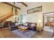 Open-concept living room featuring wood floors, a wooden staircase, and comfortable seating at 524 Deerberry Dr, Noblesville, IN 46062