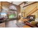 Comfortable living room featuring a vaulted ceiling, brick fireplace, and lots of natural light at 524 Deerberry Dr, Noblesville, IN 46062