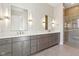 Luxurious bathroom with double vanity, marble countertop, and walk-in shower at 579 Exmoor Dr, Carmel, IN 46032