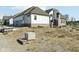 Back exterior of home with modern design surrounded by construction material and dirt at 579 Exmoor Dr, Carmel, IN 46032