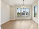 Well-lit dining area with modern chandelier and large windows showcasing the outdoors at 579 Exmoor Dr, Carmel, IN 46032
