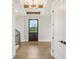 Inviting entryway features hardwood floors, a wooden door, and stairs with a wrought iron railing at 579 Exmoor Dr, Carmel, IN 46032