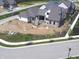 New construction home featuring gray brick, complementary stone roof, and manicured lawn in quiet cul-de-sac at 579 Exmoor Dr, Carmel, IN 46032