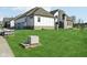 A partial view of the home's rear exterior with green grass and a modern design at 579 Exmoor Dr, Carmel, IN 46032
