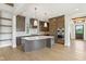 Modern kitchen boasts stainless steel appliances, a center island, and stylish lighting fixtures at 579 Exmoor Dr, Carmel, IN 46032