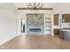 Spacious living room featuring a stone fireplace, hardwood floors, and modern lighting at 579 Exmoor Dr, Carmel, IN 46032