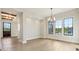 Open-concept living room with large windows, modern lighting, and hardwood floors at 579 Exmoor Dr, Carmel, IN 46032