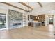 Bright living room showcasing fireplace, kitchen, wooden beams, and hardwood floors at 579 Exmoor Dr, Carmel, IN 46032