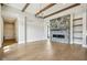 Bright living room featuring a stone fireplace, wooden ceiling beams, and hardwood floors at 579 Exmoor Dr, Carmel, IN 46032