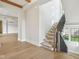 Elegant staircase with carpeted steps and black metal railings, offering a modern look at 579 Exmoor Dr, Carmel, IN 46032