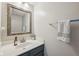 Charming half bathroom featuring a vanity, framed mirror, and towel rack, perfect for guests at 5876 E 126Th St, Carmel, IN 46033