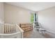 Neutral Bedroom with wood dresser, glider rocker and views of backyard at 5876 E 126Th St, Carmel, IN 46033