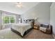 Spacious main bedroom with a ceiling fan, large window, and comfortable furnishings and decor at 5876 E 126Th St, Carmel, IN 46033
