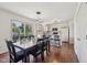 Dining area with wooden table, chairs, modern pendant lights, and view of the backyard at 5876 E 126Th St, Carmel, IN 46033