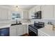 Bright kitchen featuring white cabinets, subway tile backsplash, stainless steel appliances, and modern fixtures at 5876 E 126Th St, Carmel, IN 46033