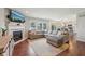 Open-concept living area with a comfortable sectional sofa, fireplace, and view into the kitchen at 5876 E 126Th St, Carmel, IN 46033