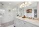 Well-lit main bathroom featuring a glass-enclosed shower, dual sinks, and modern fixtures at 5876 E 126Th St, Carmel, IN 46033