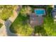 Aerial view of property featuring a beautiful backyard with a swimming pool, lush greenery, and mature trees at 601 Ridgeview Ln, Columbus, IN 47201