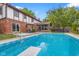 A backyard featuring a pristine pool with diving board, surrounded by patio seating and lush landscaping, perfect for outdoor enjoyment at 601 Ridgeview Ln, Columbus, IN 47201