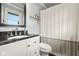 Bathroom features vanity with black countertop and white fixtures at 601 Ridgeview Ln, Columbus, IN 47201
