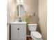 Neutral half bath featuring white vanity, stylish mirror and fixtures at 601 Ridgeview Ln, Columbus, IN 47201
