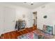 Bright bedroom with hardwood floors, organized clothing rack, and colorful books, creating a playful and inviting atmosphere at 601 Ridgeview Ln, Columbus, IN 47201