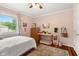 Bedroom featuring hardwood floors, a bed, dresser, desk, and natural light illuminating a comfortable and inviting space at 601 Ridgeview Ln, Columbus, IN 47201