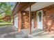 Welcoming front entrance featuring a brick facade, decorative accents, and a covered porch with a white front door at 601 Ridgeview Ln, Columbus, IN 47201