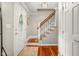 Inviting entryway featuring hardwood floors, a staircase with decorative iron railings, and a stylish front door at 601 Ridgeview Ln, Columbus, IN 47201